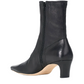 A black leather ankle boot with a pointed toe, a mid-height block heel, and a side zipper, shown from a three-quarters rear view on a white background.